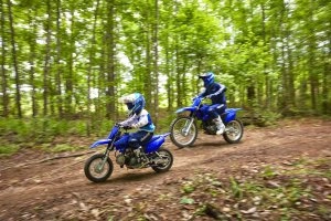 Man and kid riding in woods 3